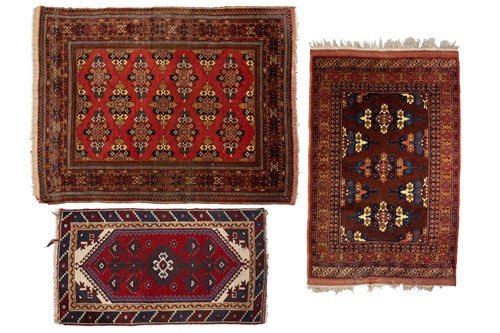 Lot 216 - A red ground Turkoman rug with rows of...