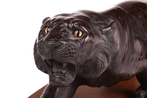 Lot 3 - A Japanese bronze okimono of a stalking tiger,...