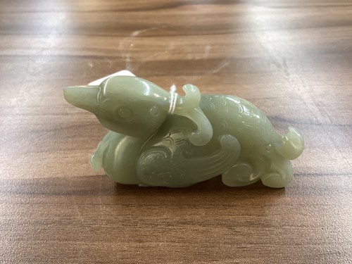 Lot 40 - A Chinese grey green carved Jade figure of a...