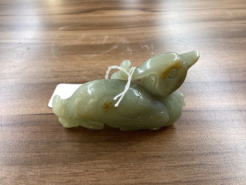 Lot 40 - A Chinese grey green carved Jade figure of a...