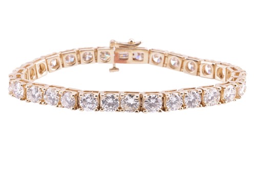 Lot 93 - A diamond line bracelet, set with a series of...