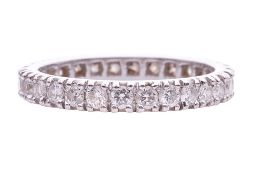 Lot 127 - A diamond set eternity ring. Set with round...