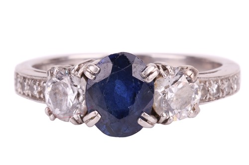 Lot 140 - A sapphire and diamond three-stone ring. The...