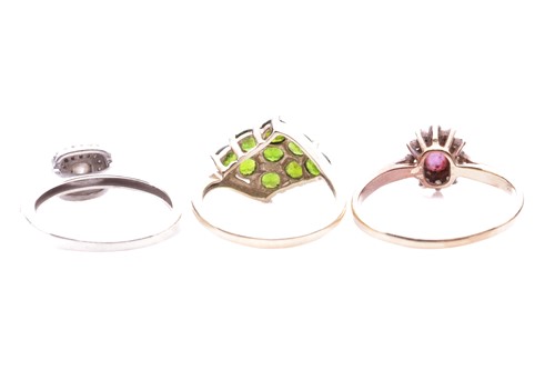 Lot 184 - Three gem-set rings including a peridot...