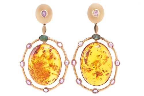 Lot 181 - A pair of reconstituted amber, emerald and...