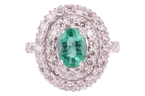 Lot 37 - An emerald and diamond cluster ring, set with...