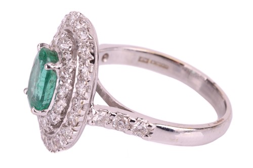 Lot 37 - An emerald and diamond cluster ring, set with...