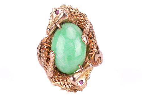 Lot 129 - A jade cabochon dress ring, the central oval...