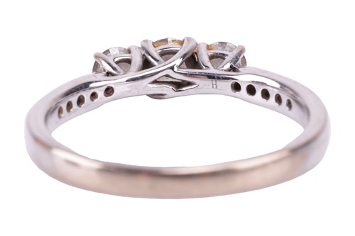 Lot 30 - A diamond three-stone ring. Set with round...