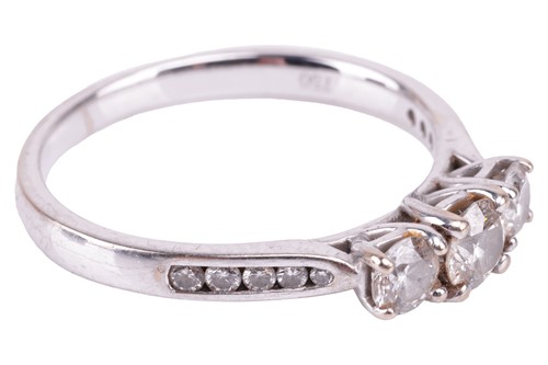 Lot 30 - A diamond three-stone ring. Set with round...