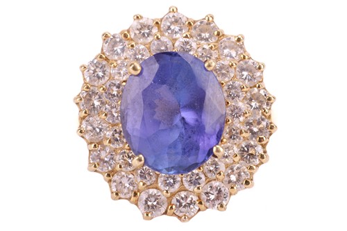 Lot 152 - A tanzanite and diamond set cluster ring. The...