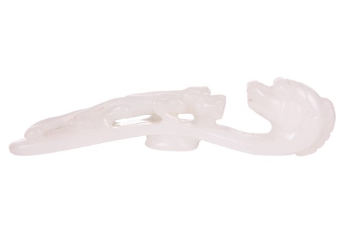 Lot 38 - A Chinese carved white jade fibular belt hook,...