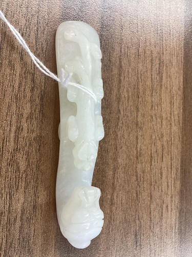 Lot 38 - A Chinese carved white jade fibular belt hook,...