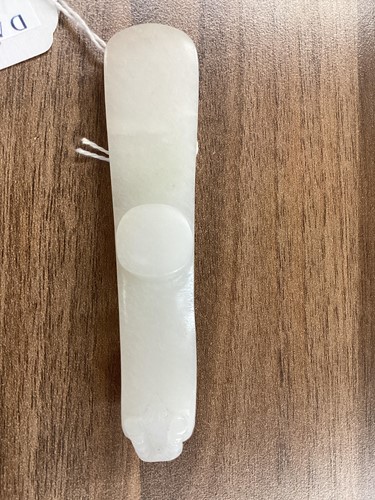 Lot 38 - A Chinese carved white jade fibular belt hook,...