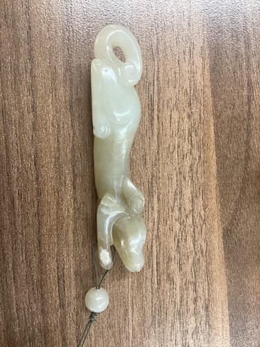 Lot 9 - A Chinese carved mutton fat jade figure of a...