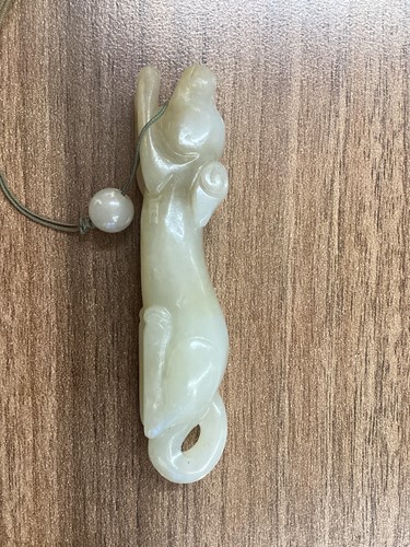 Lot 9 - A Chinese carved mutton fat jade figure of a...
