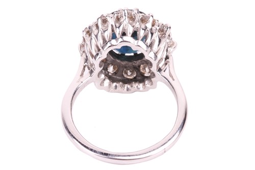 Lot 14 - A sapphire and diamond cluster ring, the oval...
