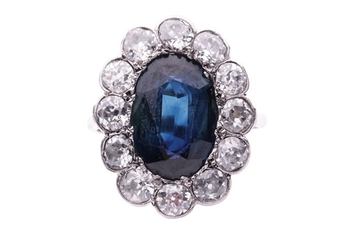Lot 113 - A sapphire and diamond cluster ring, circa...