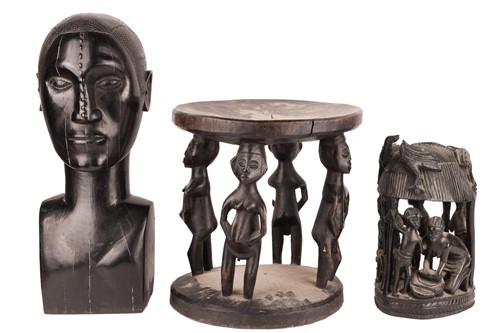Lot 57 - An African-carved wooden stool with figural...