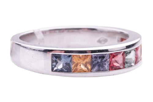 Lot 184 - A gem-set half hoop eternity ring. Set with...
