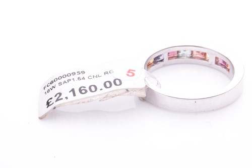 Lot 184 - A gem-set half hoop eternity ring. Set with...