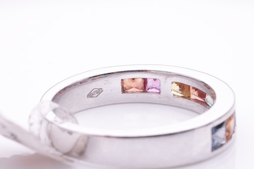 Lot 184 - A gem-set half hoop eternity ring. Set with...