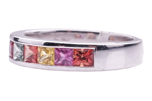 Lot 184 - A gem-set half hoop eternity ring. Set with...