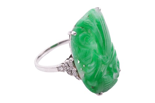 Lot 206 - An Art Deco carved jadeite dress ring, circa...