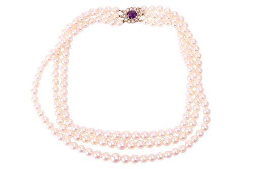 Lot 129 - A three-strand cultured pearl necklace,...