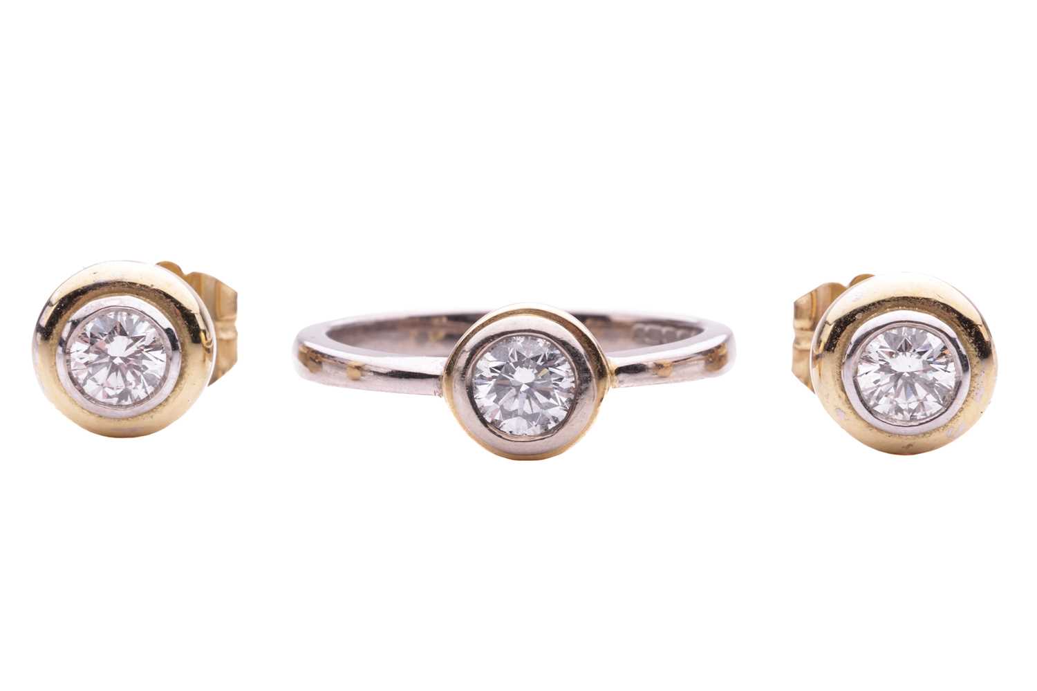Coloured Solitaire Rings Lot 181 - A diamond solitaire ring in 18ct bi-coloured