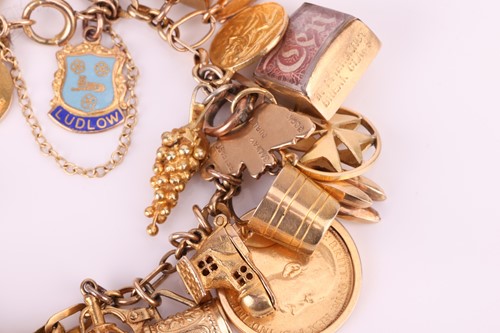 Lot 52 - A charm bracelet in 9ct gold, with a variety...