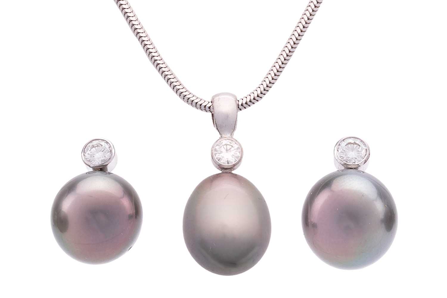 Lot 23 - A cultured Tahitian pearl and diamond pendant...