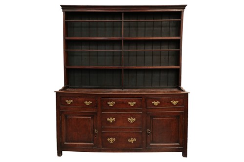 Lot 166 - A George III oak cupboard dresser and Delft...