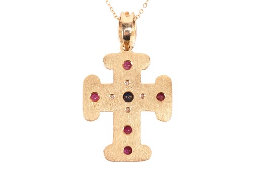 Lot 45 - A gem-set cross pendant on chain, containing...