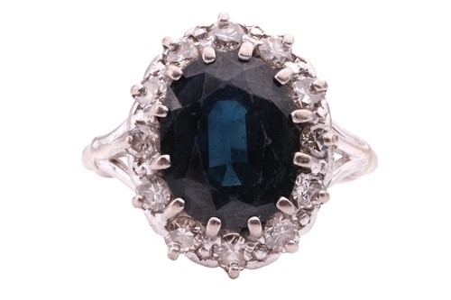Lot 81 - A sapphire and diamond cluster ring, the oval...