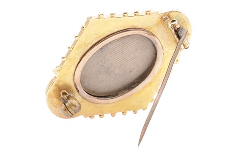 Lot 128 - An Assyrian Revival lozenge brooch, centred...