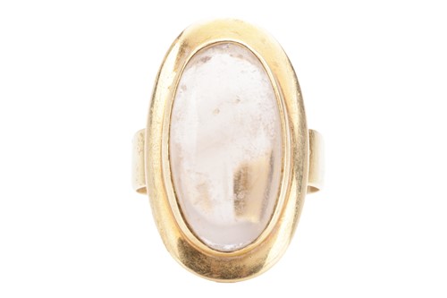 Lot 90 - A smoky quartz cabochon dress ring, featuring...