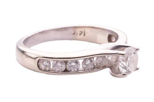 Lot 27 - A diamond solitaire ring, the central round...