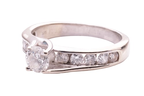 Lot 27 - A diamond solitaire ring, the central round...