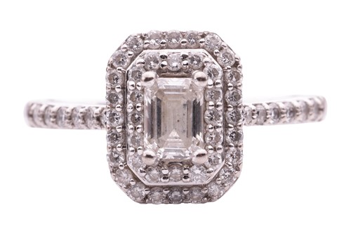 Lot 111 - A diamond cluster ring, featuring an emerald...
