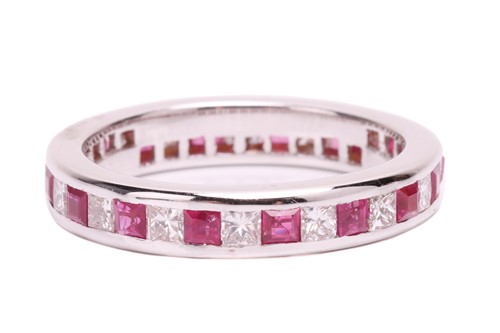 Lot 139 - A ruby and diamond eternity ring, set with a...