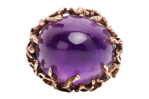 Lot 141 - A Modernist amethyst cocktail ring, featuring...