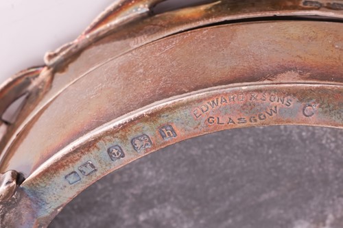 Lot 272 - An Edwardian silver oval box pierced with an...