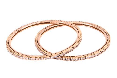 Lot 91 - A pair of diamond bangles, each set with a...