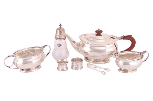 Lot 211 - A three-piece silver tea set, oval with husk...