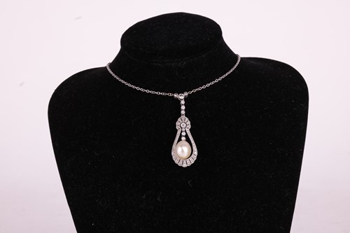 Lot 1 - A natural saltwater pearl and diamond lavalier...