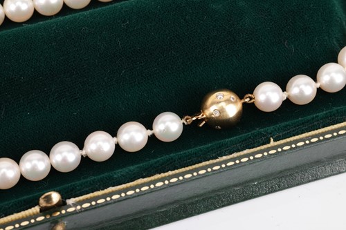 Lot 29 - A cultured pearl necklace with diamond-set...