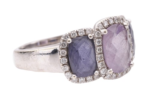 Lot 90 - An amethyst and diamond halo dress ring in...