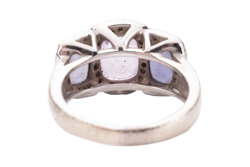 Lot 90 - An amethyst and diamond halo dress ring in...