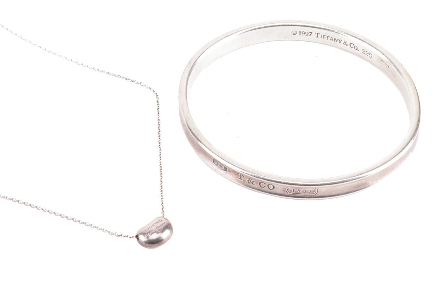 Lot 8 - Tiffany & Co. - an 1873 closed bangle and an...